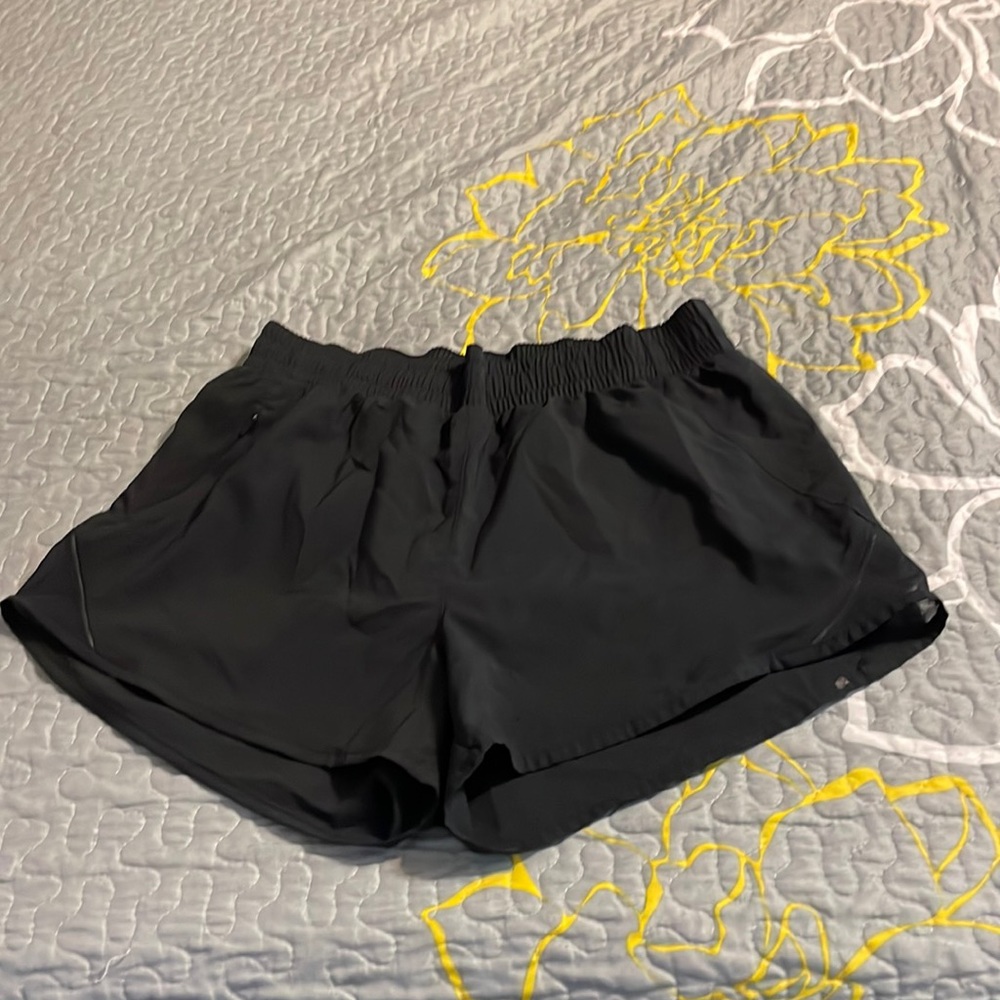 Black shorts with pocket and mesh cut outs at the bottom on the side